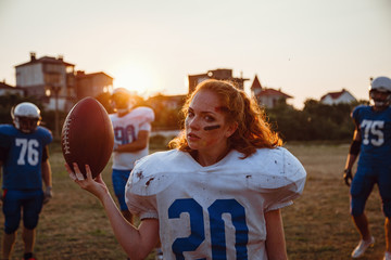 American football woman player in action on the stadium.