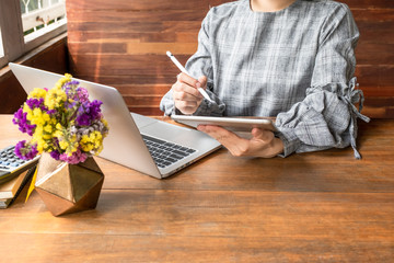 Business woman working at home with her laptop and tablat