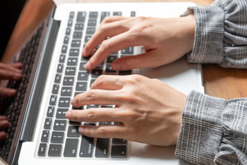 Picture of business woman hands working at home with her laptop