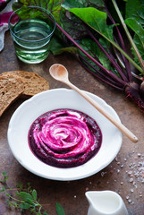 Creamy Beetroot soup on brown wooden background