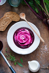 Creamy Beetroot soup on brown wooden background
