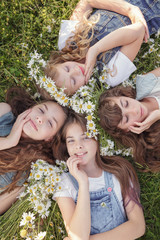 Four Teen girls enjoys spring in daisy field.