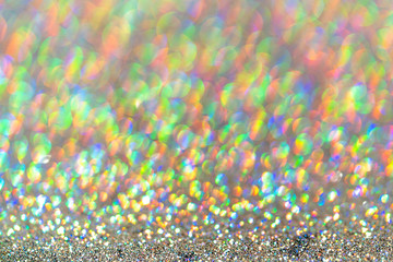 Abstract shiny colored sparkles background with blur bokeh.