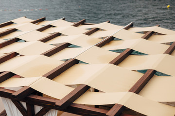 Unusual roof closure. The roof of the restaurant on the street by the sea. Fabric roof 