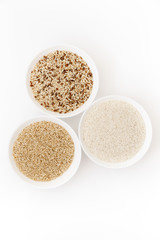 Bowls with different types of raw uncooked rice: brown, red, white, glutinous. The most popular asian healthy food, top view