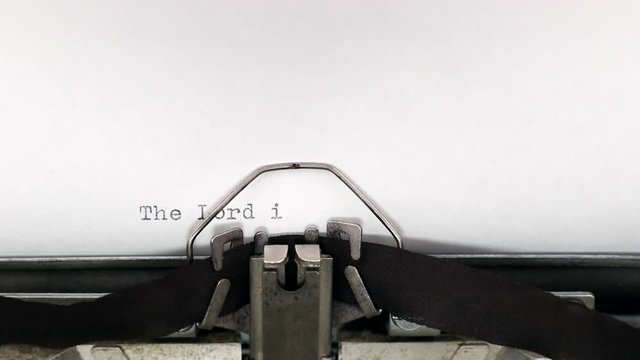 Typing a popular holy bible quote the Lord is my shepherd, I lack nothing on a vintage typewriter