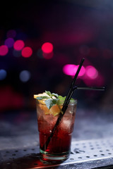 Colorful footage in a nightclub. Alcoholic drink cocktail with lime and mint. Nightlife scene