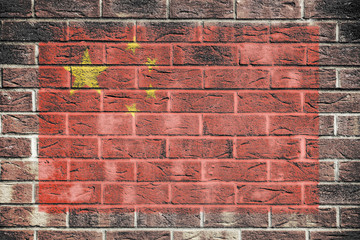 Peoples Republic of China flag on brick wall background