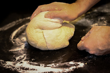 Delicious homemade bread being produced.
The dough is being kneaded.