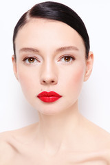 Portrait of young beautiful woman with clean makeup and red lipstick