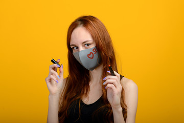 Portrait of a girl in a mask, which puts on a rubber glove. Yellow background.