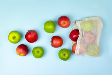 fruit apples in caton mesh bags on a blue background. zero waste concept. No plastic.