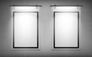 Blank movie posters illuminated by spotlights. Vector realistic mockup of white picture frames on gray tiled wall in cinema, theater or gallery. Empty advertising banners with black border and lamps