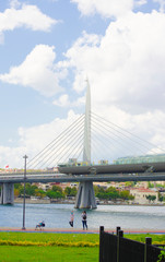 Golden Horn Metro Bridge, bearing supports, pleasure tourist ships. Urban modern concept, historical background. Copy space. Selective focus Turkey, Istanbul, Bosphorus