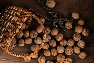 Nuts in a straw woven basket on a wooden table.