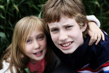 Portrait of sister  with her autistic brother enjoying  freedom and summer. Ending coronavirus...