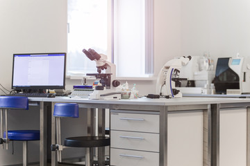 laboratory with modern equipment for blood analysis. The doctor checks the blood of patients. Microscope on the table. Blood test at a modern scientific workplace.
