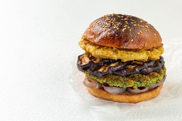 Fresh vegan chickpea burger with onion and grilled eggplant. The concept of healthy and vegetarian food. Place for text