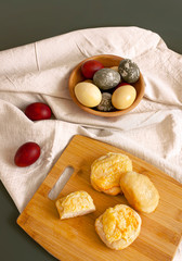 Rustic background. Easter. Colored eggs and homemade bakery products on a woven fabric