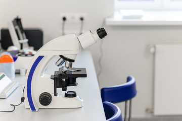 laboratory with modern equipment for blood analysis. The doctor checks the blood of patients. Microscope on the table. Blood test at a modern scientific workplace.