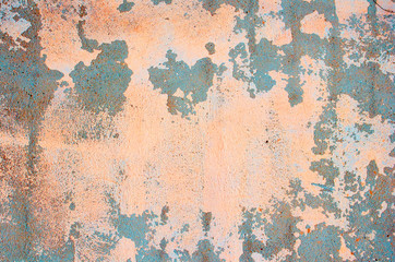 Old concrete wall. Peeling plaster on wall of house, building or fence surface. Toning in bright neon pink and blue colors. Modern urban backdrop. Copy space. Place for text. Selective focus image.