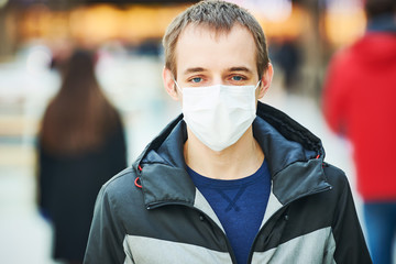 man with protective face mask at public place. corona virus outbreak