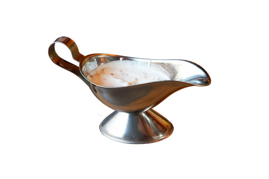 Metal gravy boat isolated on a white background. Stuffed Gravy Boat with cream sauce