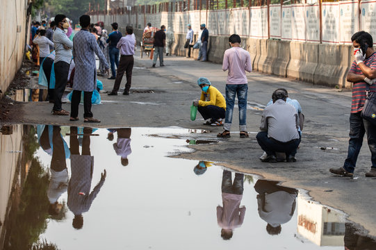 People wait for hours in long queues for Covid-19 tests at BSMMU fever clinic near Shahabagh in the capital of Bangladesh ,Monday morning on April 20,2020. Photo:Saikat Bhadra