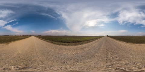 Fototapeta na wymiar full seamless spherical hdri panorama 360 degrees angle view on gravel road among fields in spring day with clear sky in equirectangular projection, ready for VR AR virtual reality content