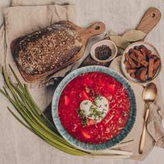 Ukrainian and Russian traditional beet soup borsh with sour cream in a bowl. Rustic style.