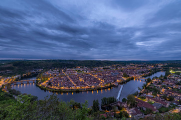 the Lot river is curving around the city of Cahors making a great horse shoe. The lights are on in the twilight