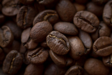 Extremely close-up background roasted coffee beans with gold streaks, good morning concept