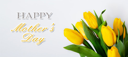 Bouquet of yellow tulips with congratulations on Mother's Day