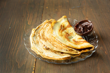 Chocolate pancakes on a wooden table