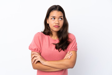 Fototapeta premium Young Colombian girl over isolated white background making doubts gesture while lifting the shoulders