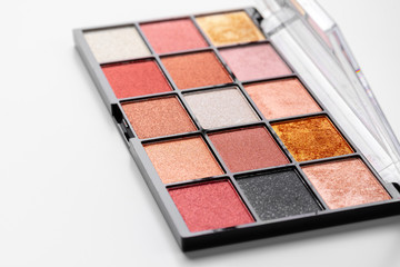 Make up colorful eyeshadow palettes on white, close up