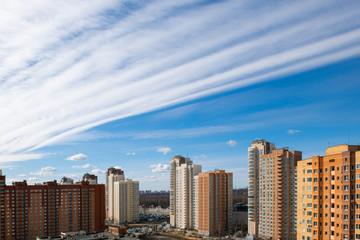 Fototapeta na wymiar Modern high-rise architecture with scenic clouds on blue sky