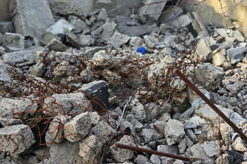 Destroyed brick walls of houses with rusty iron structural elements