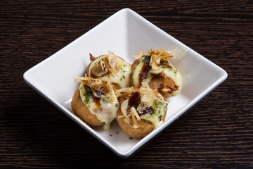 Tako Yaki on a white plate.