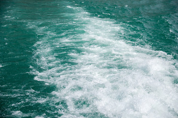 Waves in the sea with white foam.