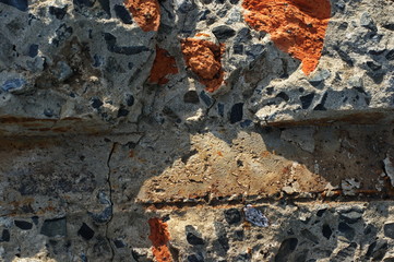 Destroyed brick walls of houses with rusty iron structural elements