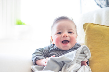 Cute baby smiling in a bright room