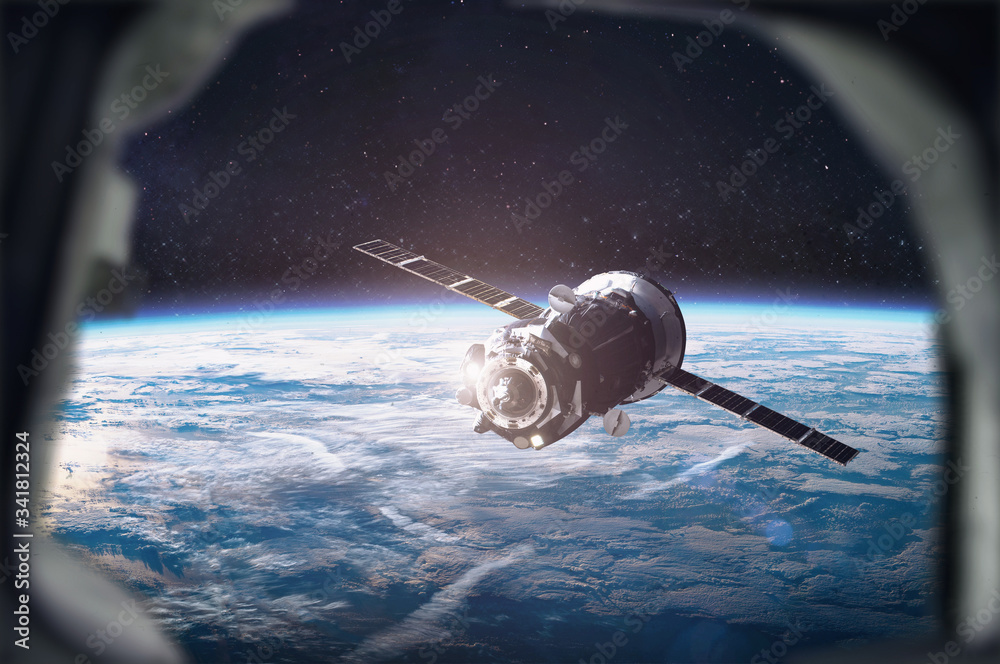 Wall mural space ship on orbit of earth planet. view from porthole of iss. space station with astronauts. eleme