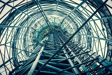 Steel structure of the observation tower in Batumi. Iron pipes create a futuristic image of the structure. Web of metal. View from the bottom up. Day Cloudy.