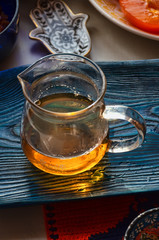 glass bowl full of tea on the wooden tray