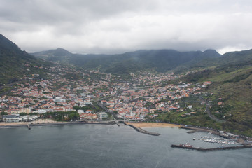 Fototapeta na wymiar View of Funchal harbor on Madeira island in Portugal prior to landing on the island. Soft focus from airplane window.