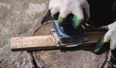 sanding machine sanding wood, sandpaper, hands and tools, working tools for repair, wooden