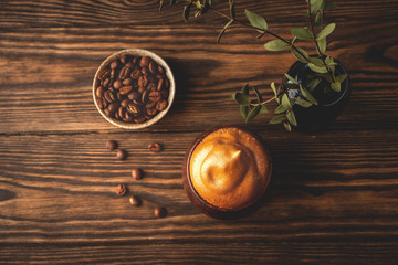 fluffy whipped coffee, dalgona coffee,vintage wooden glasses with a beverage, trend korean drink, top view, copy space