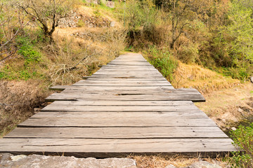 Rustic bridge on the forest, wood and stones