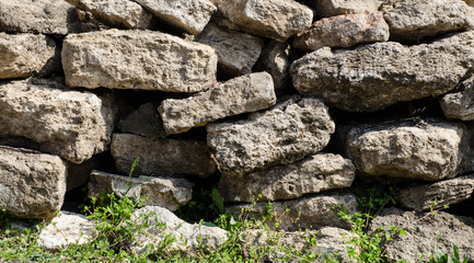 Stone fence. Fence made of bricks, stone, tiles. The structure of brick, stone.